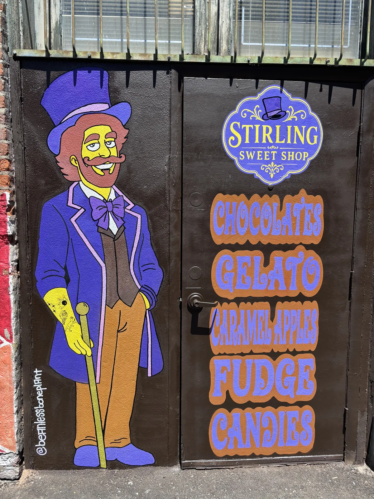 The purple-suited Stirling mascot painted on a back door in Freak Alley